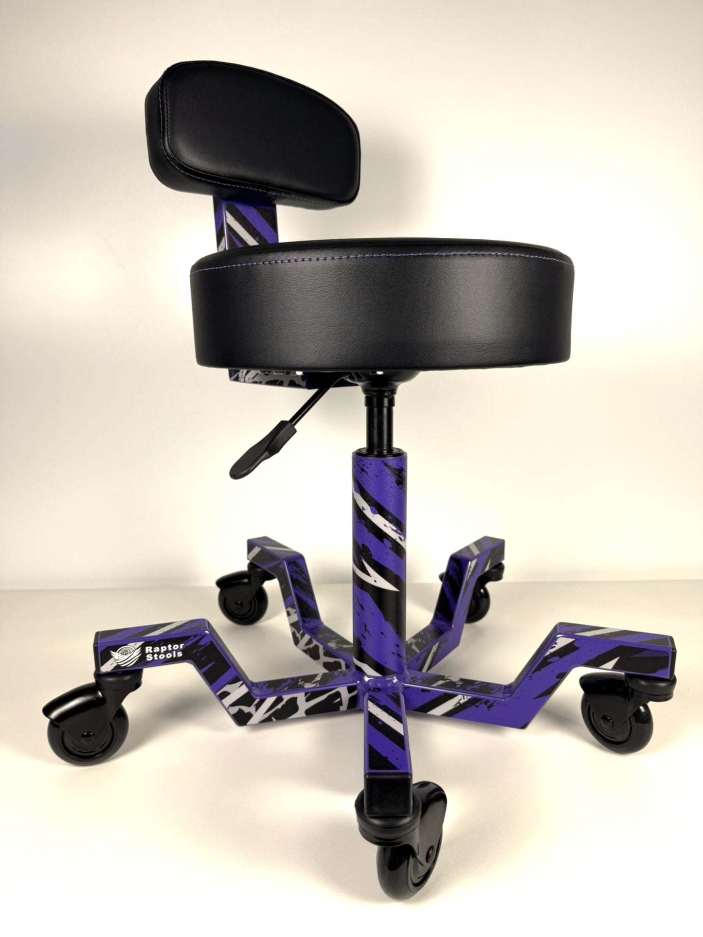 Black and purple adjustable stool with wheels on a white background