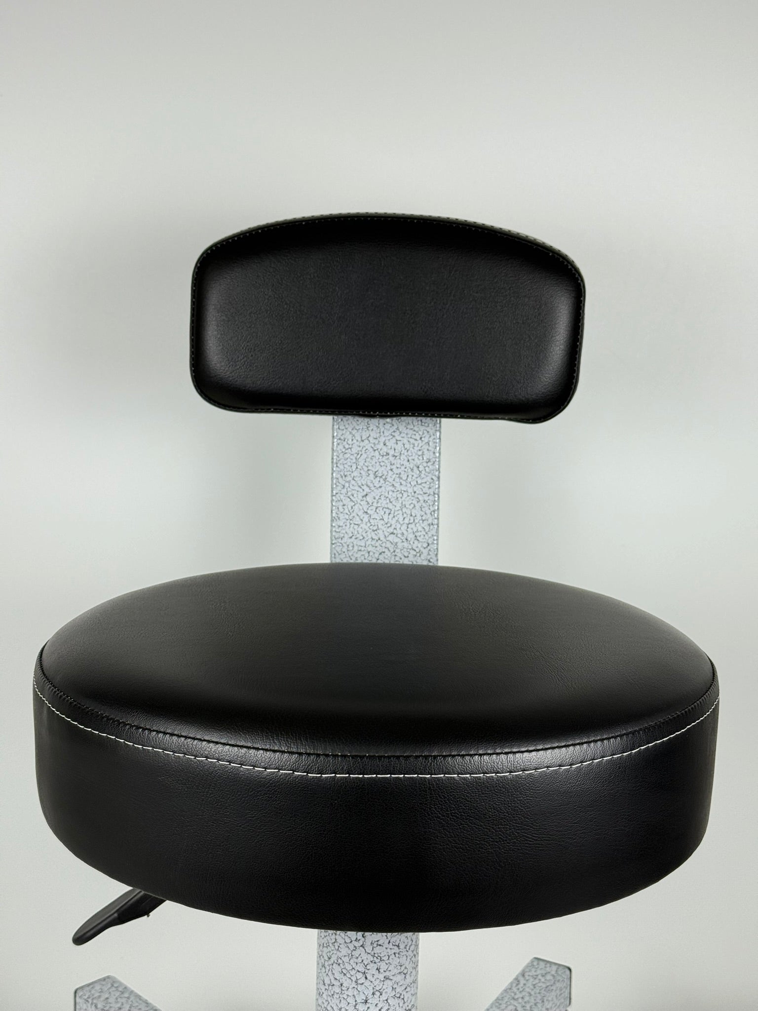 Black leather chair with a gray metal frame on a white background