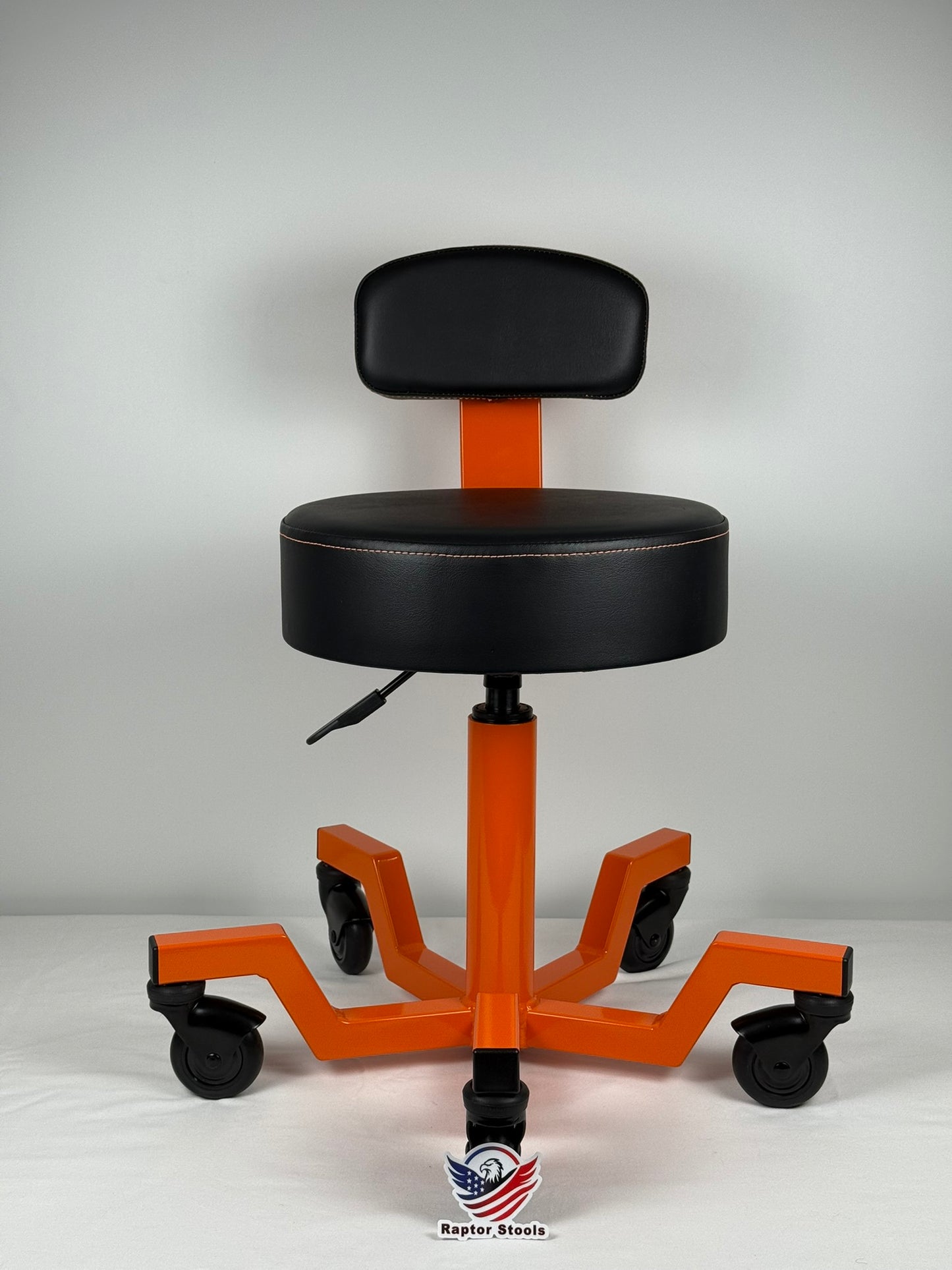 Orange and black adjustable stool with wheels on a white background
