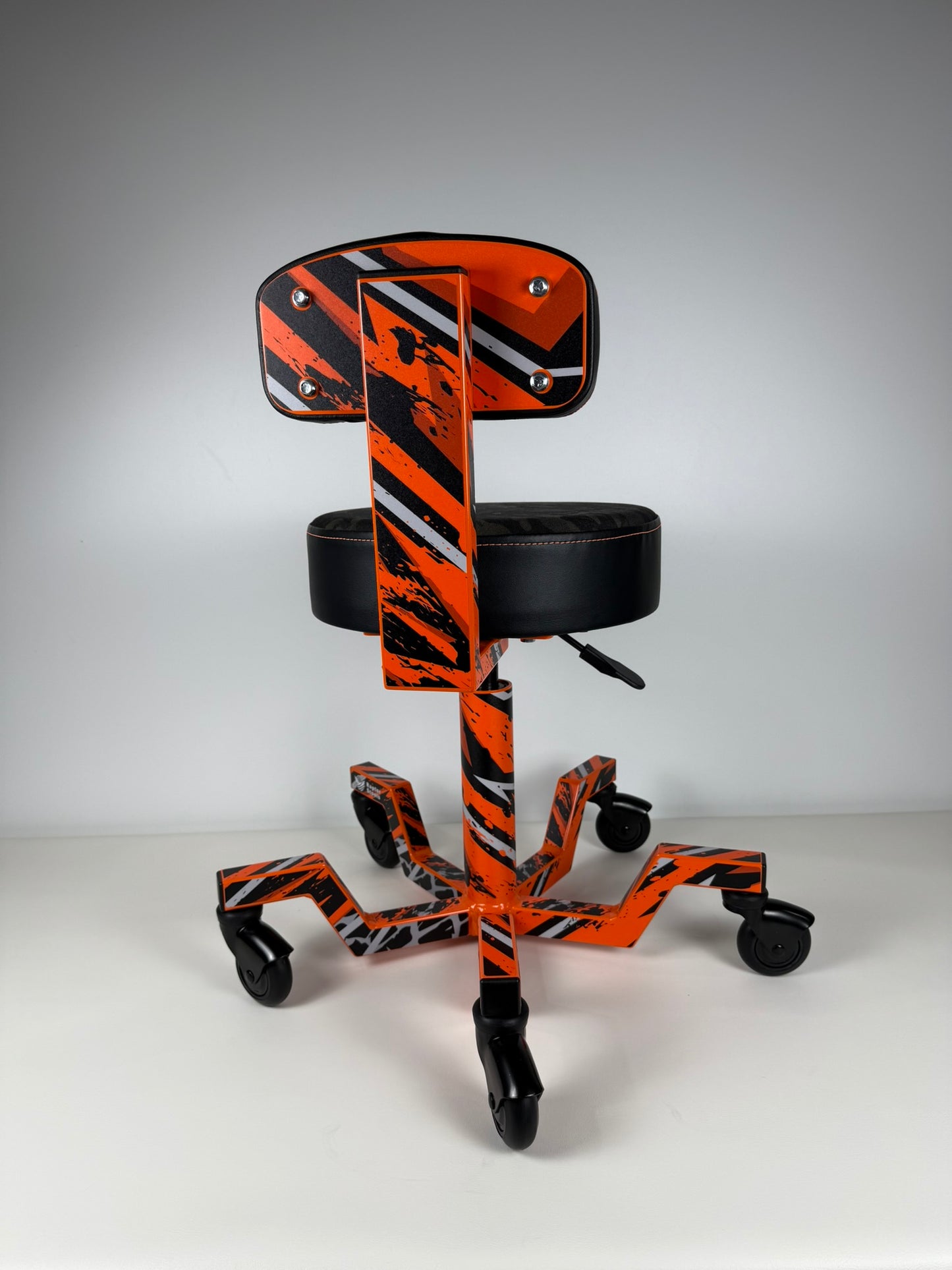 Orange and black striped chair with a black seat on a gray background