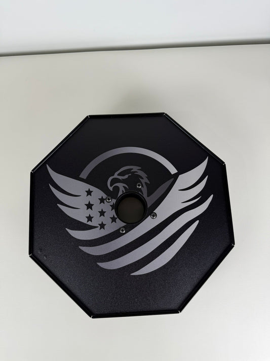Black octagonal object with gray eagle and star design on a white background